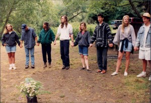 A group of people standing in the grass.