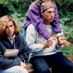 A group of people sitting on top of a bench.