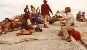 A group of people sitting on the ground.