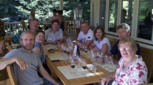 A group of people sitting at a table with wine glasses.