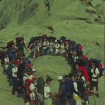 A group of people standing around in the middle of a circle.