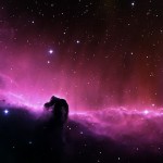 A purple nebula with stars in the background.